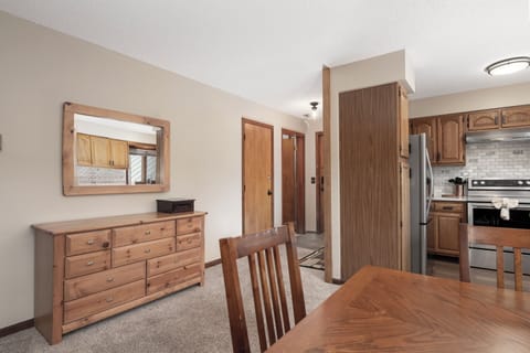 Your rustic dining area flows seamlessly into the fully equipped kitchen, creating the perfect space for memorable meals together.