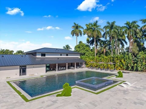 Private outdoor oasis with dining space, lounge seating, and lush landscaping.