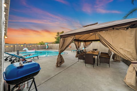 Grill, dine, and unwind in this inviting outdoor space under a stylish tent.