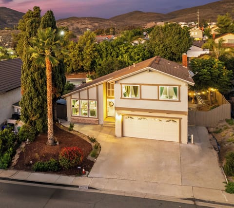A stunning aerial view featuring the house and its well-designed driveway.