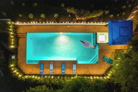 A serene night view — unwind with a dip in the softly lit pool.