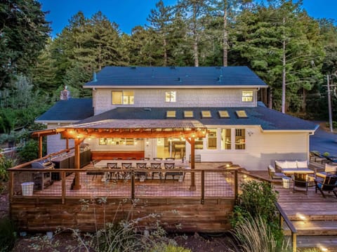 Spacious outdoor deck with cozy seating and forest views