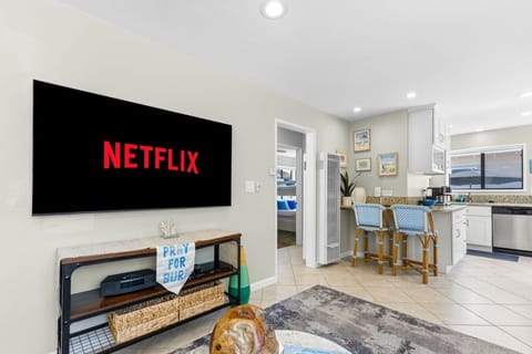 Unwind in the bright living area equipped with plush seating, smart streaming TV, and coastal decor—the perfect spot for relaxation after a day exploring Mission Beach.