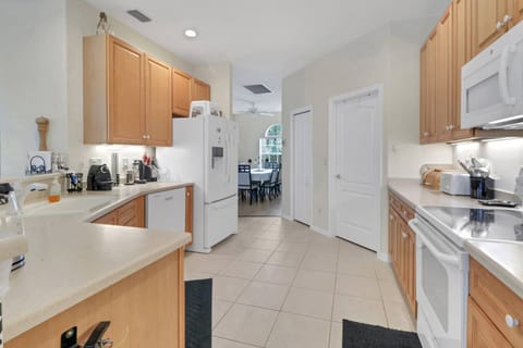 The open kitchen is well equipped with full-sized oven, microwave, refrigerator/freezer and dishwasher.