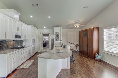 Well-equipped kitchen with modern appliances and breakfast bar.