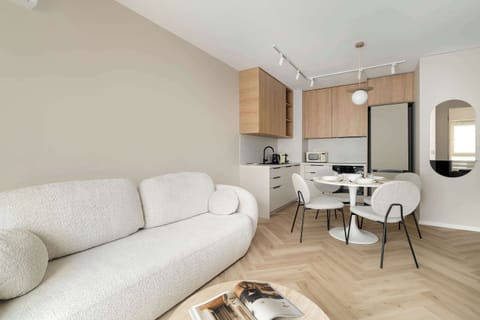 Relax in the stylish living room with a comfortable sofa and modern decor.