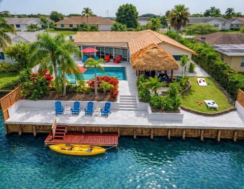 Welcome to your Boynton Beach waterfront oasis, featuring a heated pool, tiki hut, and canal views—your private slice of South Florida paradise for families and groups.