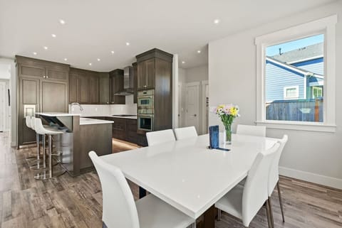 Bright open kitchen and dining area with elegant finishes, perfect for gathering over home-cooked meals and local wine after a day of exploring McMinnville.
