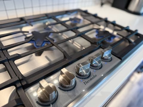 Premium Thermador gas range — the centerpiece of your gourmet kitchen, ready for everything from wine pairings to home-cooked feasts.
