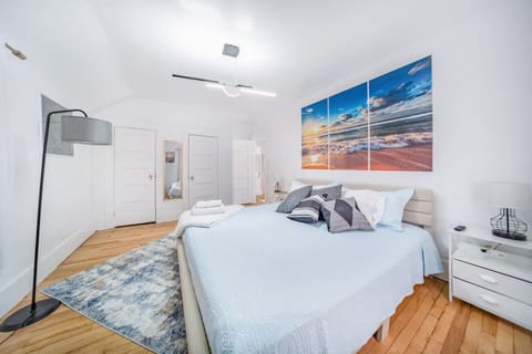 Step into a bright and tranquil sanctuary in Bedroom 1, where coastal charm meets modern comfort. This spacious retreat features a plush King-size bed perfectly positioned across from a wall-mounted flat-screen TV for relaxing movie nights.