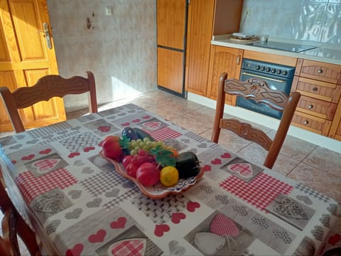 the kitchen table; light coming in from outside through the open door.