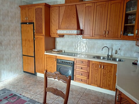 the kitchen: fridge-freezer, cooker, sink, cupboards and units.