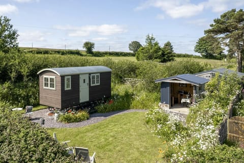 View of the shepherds hut and the outside dining cabin