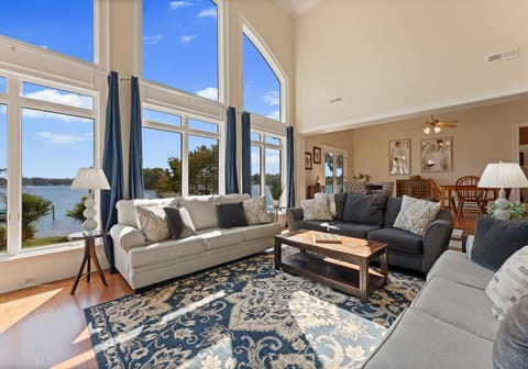 Main sitting area with living room. Three, three seater couches, with wall of windows and TV!