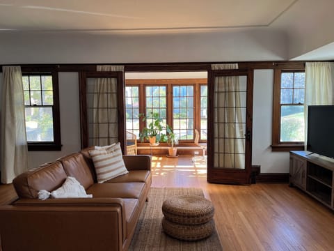 Living room leading into sunroom.