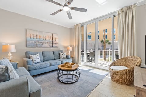 Bright and welcoming living area featuring a Smart TV with cable, comfy sleeper sofa, and easy access to the balcony.