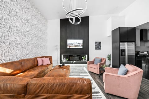 Bright and airy space featuring a chic sectional, modern decor, and a stunning design.