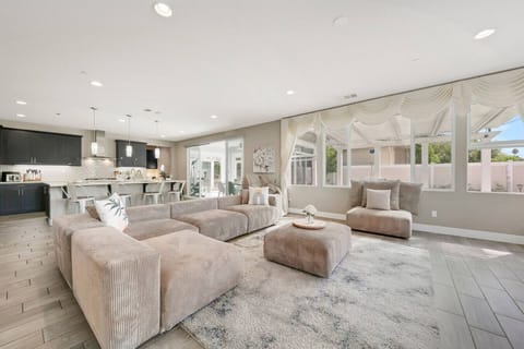Open-concept living area with large windows, sectional seating, and family-friendly comfort.
