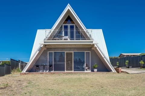 This striking A-frame façade captures the home’s modern coastal architecture, with ample parking and a breezy sense of arrival just a short walk from the shore.