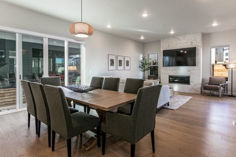 a large dining room with seating for 8 at the table and another 6 at the Island