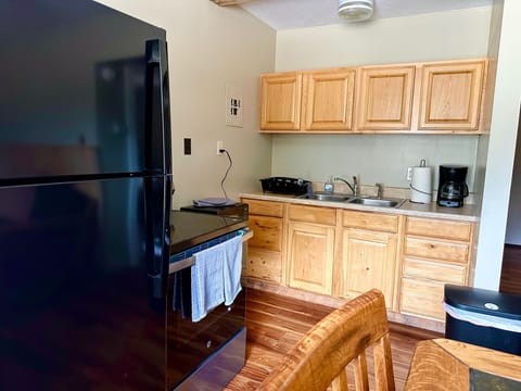 Fully equipped kitchen with pots, pans, and dishes