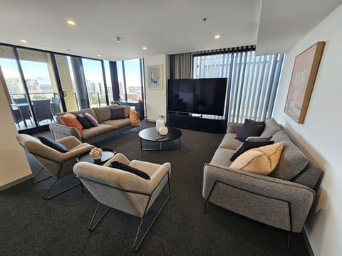 Sink into the spacious living area with plenty of seating, an impressive 85-inch Smart TV, and room to truly unwind after a day exploring the city.