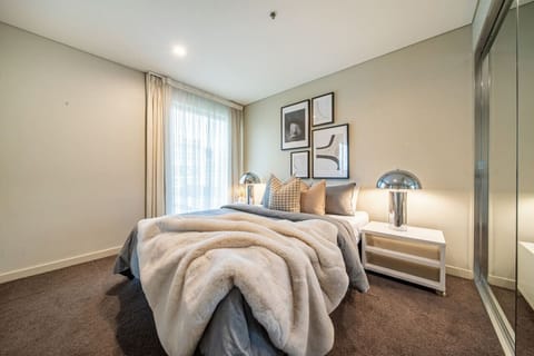 Wake to soft light in the primary bedroom, where a queen bed offers a calm retreat.