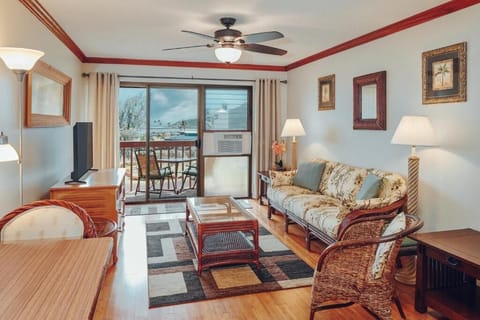 Relax in the airy living room with breezy balcony views.