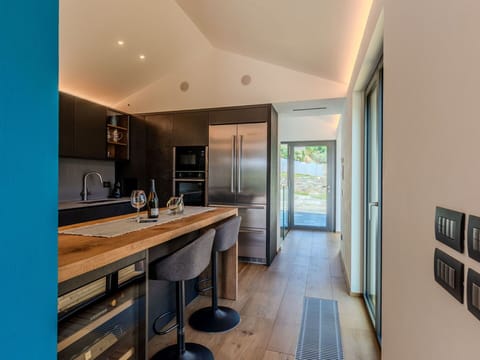 Furniture, Interior Design, Flooring, Countertop, Kitchen, Floor, Ceiling, Wood, Light Fixture, Cabinetry