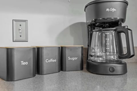 Fully stocked kitchen, with 4 barstools overlooking the backyard. We have a children's clip on high chair, kids dinnerware, complimentary coffee, tea, sugar, and creamer, as well as all your cooking needs on site.