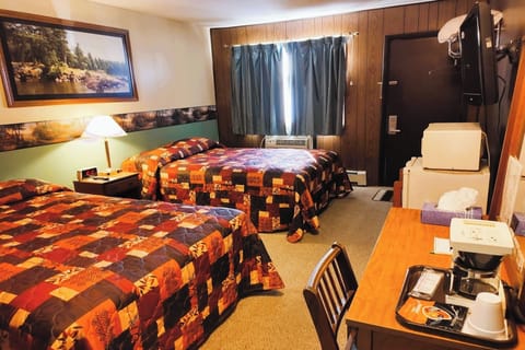 Unwind in a cozy room with two beds and warm lighting