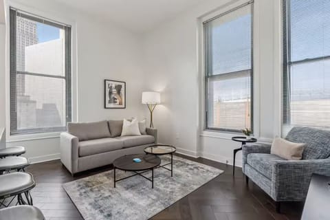 Stretch out on the sofa beneath oversized, sunlit windows.