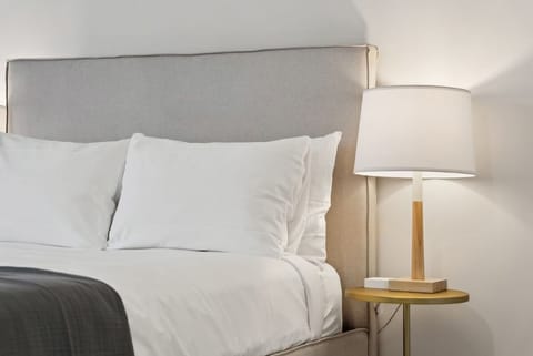 Wake slowly beside warm lamplight and plush pillows.
