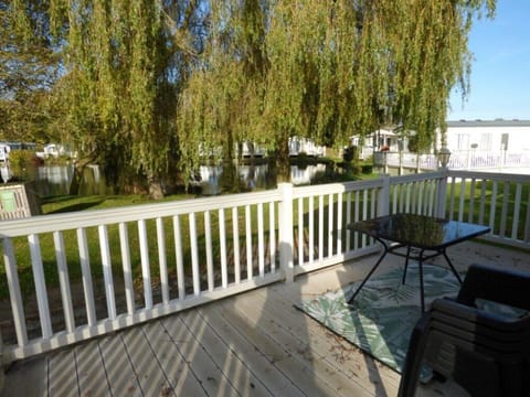 Sunny deck with cozy seating and peaceful tree views