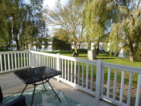 Peaceful backyard patio with serene lake views and lush greenery