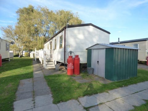 Cozy outdoor space with ample parking and storage shed