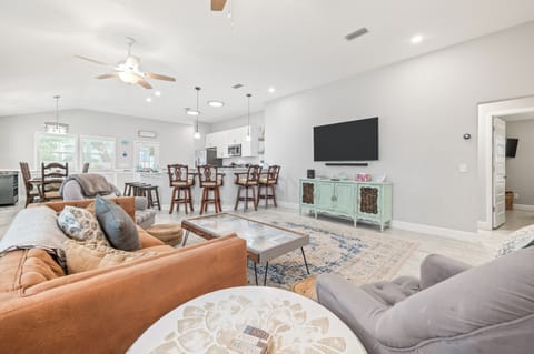 Open-concept living area with TV and dining space.