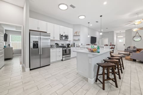 Open kitchen with full appliances and large island.