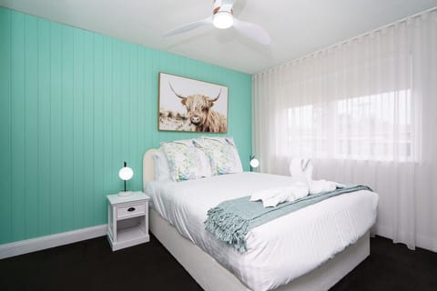 Peaceful bedroom retreat with soft linens and relaxing light. Rest easy and recharge.