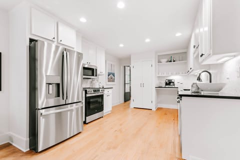 Modern kitchen with stainless steel appliances, ideal for cooking and sharing meals together.