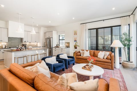 2nd Floor: Warm and inviting open-concept living area with a smart TV and plush furnishings