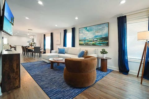 Bright open living room with hardwood floors and elegant Craftsman charm