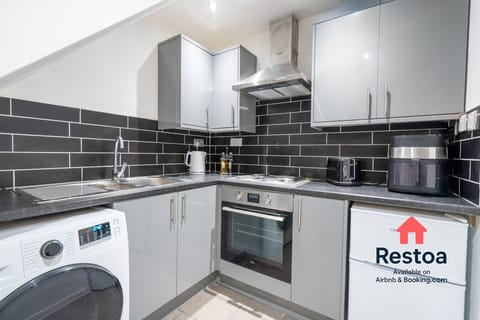 Fully equipped kitchen area with oven, hob and fridge, shared between 4 studios