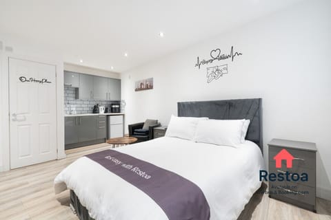 Comfortable sleeping area with view of kitchen