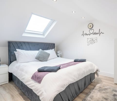 Comfortable double bed beneath a skylight for restful nights