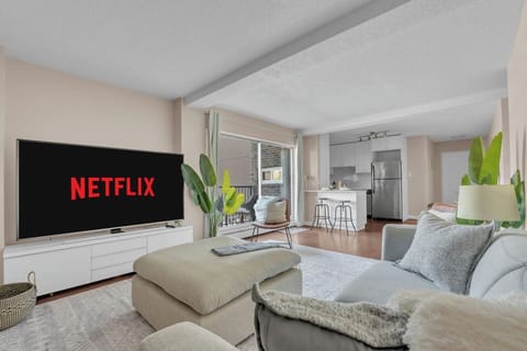 Inviting living room with a plush seating area and a 75-inch smart TV for elevated entertainment
