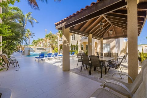 Enjoy the perfect blend of shade and sunshine at the covered poolside table. A cozy spot to sip your morning coffee, share meals, or simply unwind while taking in the serene pool views