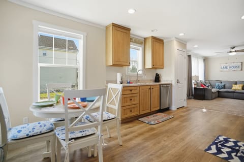 Open concept living area with dining, kitchen and living room all open.