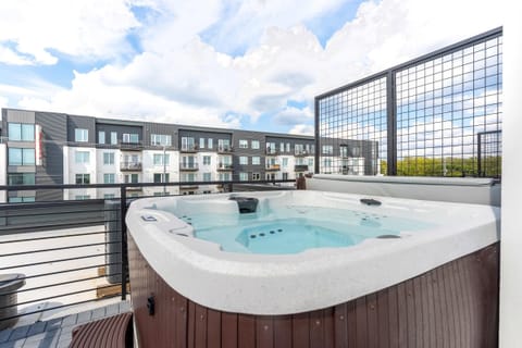 Unwind in this luxurious rooftop hot tub with stunning city views—perfect for family reunions or chic bachelorette parties. Your ideal downtown getaway awaits!