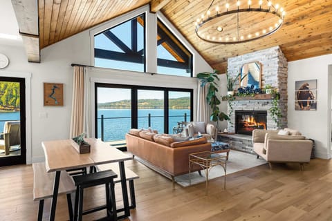 Wake to shimmering lake views and golden light filling this vaulted great room — where every sunrise feels like a private postcard.